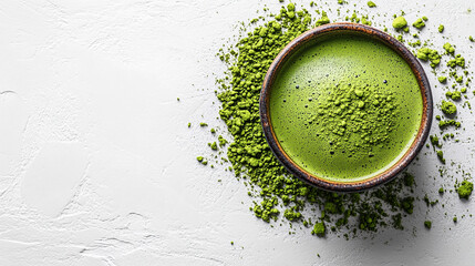 A top-down view of a matcha green tea cup placed on a white surface, showcasing the vibrant green tea in a minimalist and clean setting. The simple composition highlights the calm and refreshing natur
