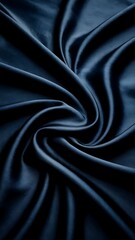 Smooth, soft, shiny black silk satin fabric with a rippled texture creates an elegant and luxurious backdrop	