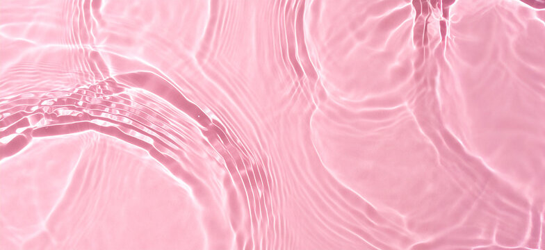 Crystal clear pink beach water with gentle ripples