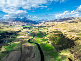 Farms and Mountains over River Dochart and Road A85 from a drone, Perthshire, Scotland, UK