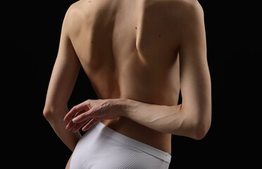 Naklejka premium Woman with perfect skin on black background, closeup