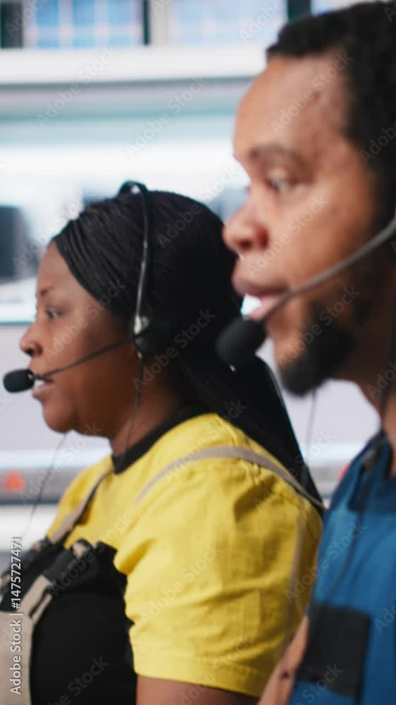 Poster vertical video engineer provides technical support via headset in solar panel factory, operator assi
