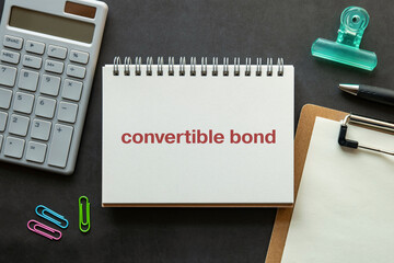 There is notebook with the word convertible bond. It is as an eye-catching image.