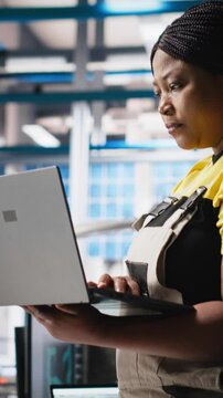 Vertical Video Photovoltaics factory technician designing CAD models and technical sketches for solar modules on laptop. Woman engineer ensures solar panel designs for efficiency and manufacturability