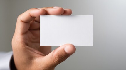 Fototapeta premium Blank White Business Card Mockup in Hand with Neutral Background