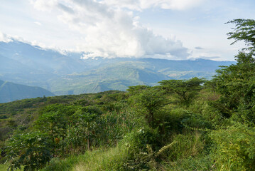 Fototapeta premium Colombian Andean landscape, mountains covered with lush, green vegetation. View from a lookout point in Guane, Santander.