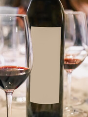 Blurred Wine bottle with blank label and glasses displaying elegance