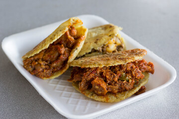 An appetizing image featuring crispy gorditas filled with savory meat, showcasing a popular Latin American street food that promises flavor and satisfaction in every bite.