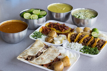 A vibrant layout featuring traditional Mexican tacos alongside delicious sides, including potatoes and sauces, representing the rich culinary traditions of Mexican cuisine.