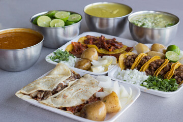An appealing assortment of authentic Mexican tacos accompanied by various sides, showcasing the simplicity and richness of traditional Mexican cuisine.
