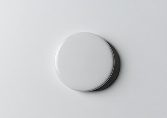 A plain white circular button on a light background