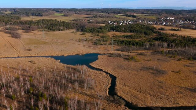 Aerial view of Upper Wurm River between Starnberg and Leutstetten, Bavaria. Clear water, wetlands, green meadows, and forests. Only outflow of Lake Starnberg, flowing through nature reserve in spring