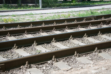 close-up of tram rails and concrete sleepers covered with crushed stone