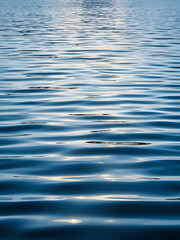 Tranquil image of gentle ripples on the water's surface, serene, peaceful, calm, reflection, nature, blue, surface, texture