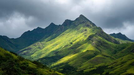 Fototapeta premium Majestic Green Mountain Landscape Under Dramatic Cloudy Sky