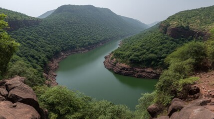 Serene River Flowing Through Lush Green Hills in Scenic Landscape