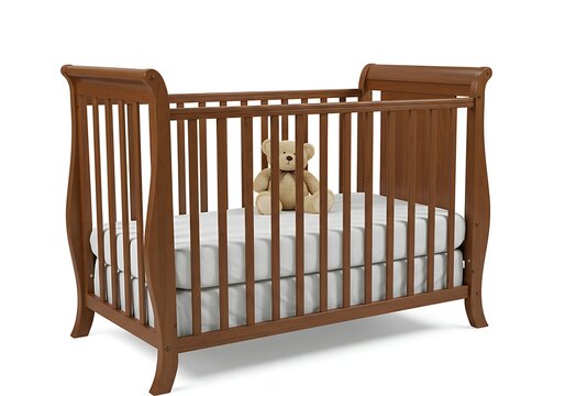 Brown wooden crib with teddy bear inside on white sheet