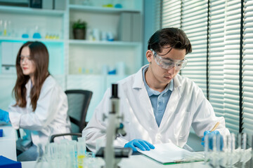 Fototapeta premium Asian male and female scientist work together in the research laboratory.
