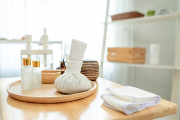Shot of spa herbal bag and bottles of cosmetic products in beauty spa.