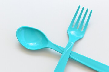 blue spoon and fork isolated on white background, plastic cutlery for picnic