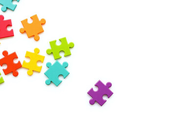 Fototapeta premium pile of colorful puzzle pieces on a white surface