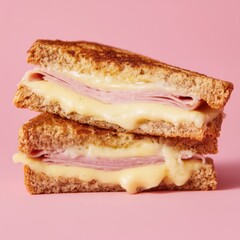 Stacked ham and cheese sandwich close up studio shot on pink background delicious lunch comfort food tasty simple