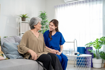 Asian beautiful caregiver examine senior woman patient at nursing home. 