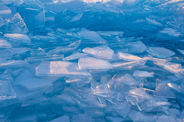 Endless hummock field on frozen Lake Baikal. Piles of snow-covered debris of blue ice on frosty day