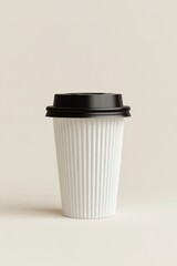 Minimalist studio shot of a white paper coffee cup with a black lid on a neutral background simple and clean design for branding mockups