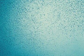 Textured light teal wall.  Surface has small, granular, consistent pattern