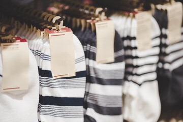Blank tag on Striped Cotton Socks Display in Retail Store. Fashion and Comfort Concept.