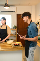 Young couple preparing pancake batter together in a cozy kitchen