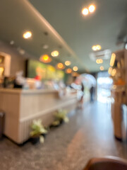 blurry image showing the interior of a cafe or shop. The scene is out of focus, with indistinct...