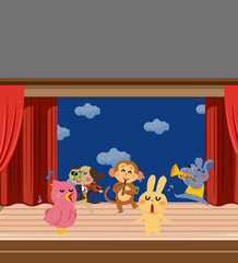 a group of animals playing musical instruments on stage seen by many spectators.