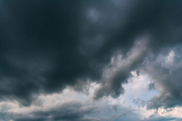Dramatic dark storm thundercloud rain clouds on black sky background. Dark thunderstorm clouds rainny landscape. Meteorology danger windstorm disaster climate. Dark cloudscape storm disaster gray sky