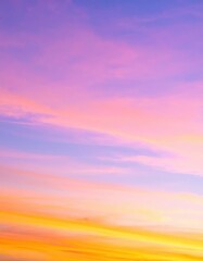Obraz premium A vibrant sunset sky painted with hues of orange, pink, and purple, scattered clouds reflecting the warm light, creating a breathtaking natural canvas.