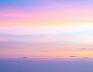 Fototapeta premium A vibrant sunset sky painted in hues of orange, pink, and purple, adorned with fluffy white clouds drifting lazily across the horizon.
