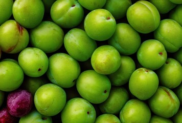 Fresh Green Plums and Ripe Red Plums Gathered Together on a Wooden Surface, Displaying Natural Colors and Textures for Culinary Inspiration