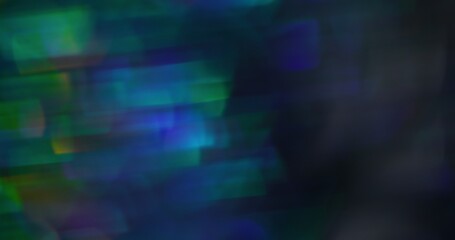Obraz premium Kaleidoscope reflection. Blur optical leak. Gleaming green blue color lens flare abstract modern light background.