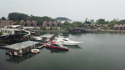 Boats travel on the sea and fill the harbor by the coast