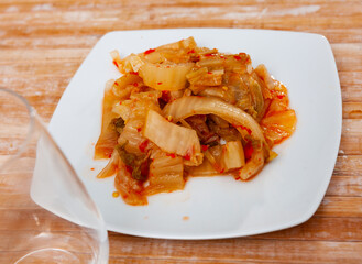 Spicy pickled napa cabbage kimchi with minced habanero on palte Typical Korean vegetable side dish..