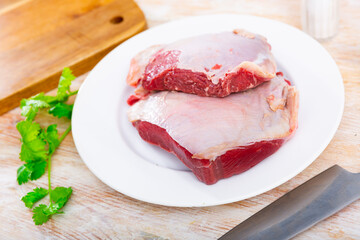 Raw beef tenderloin and spices, set of products for cooking baked and fried steak. Raw beef veal meat on board. Raw beef tenderloin and spices, set of products for cooking baked and fried steak