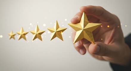Hand holding a golden star with four other stars in the background