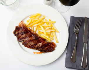 Grilled beef sirloin with roasted potatoes on plate