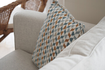 Decorative patterned pillow on a cozy sofa in a bright room
