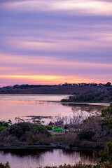 Fototapeta premium Amazing sunset over the lakes with a car driving between lakes, Tower Hill, Victoria, Australia