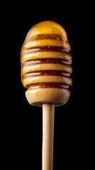 Honey dripping from a wooden dipper close up studio shot against black background food photography