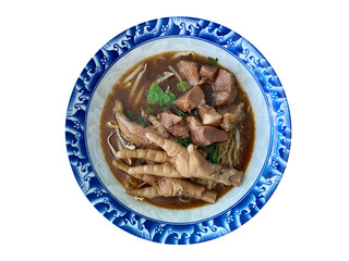 Stewed pork noodles with chicken feet isolated on white background.