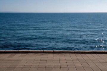 there is a man sitting on a bench looking out at the ocean