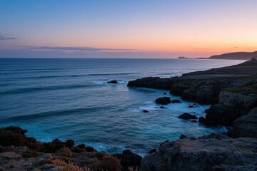 arafed view of a beach with a body of water and a cliff